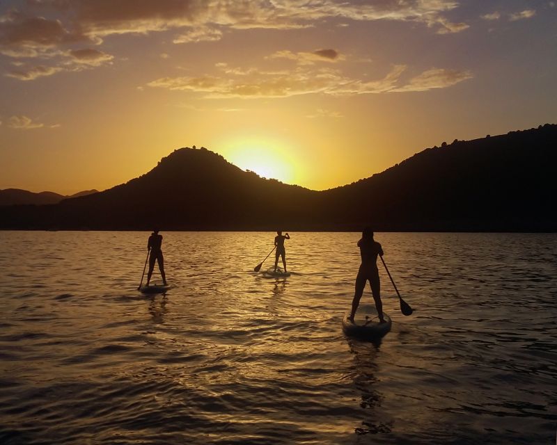 Cala Rajada: Stand Up Paddle Sunset Tour - Paddling through Cala Agulla as evening settles