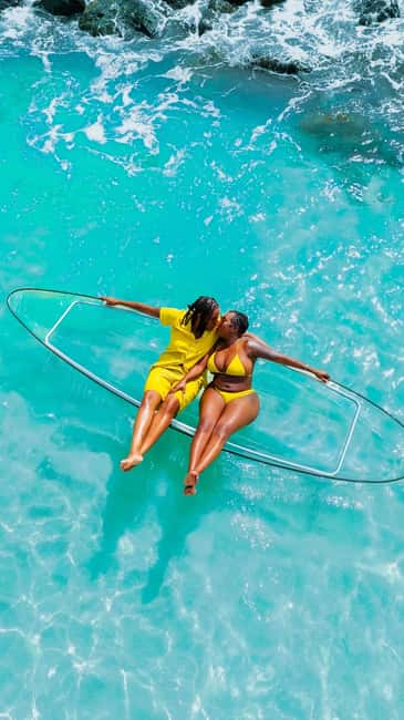 Drone Clear Kayak Barbados Photoshoot - Entering the clear kayak in shallow water