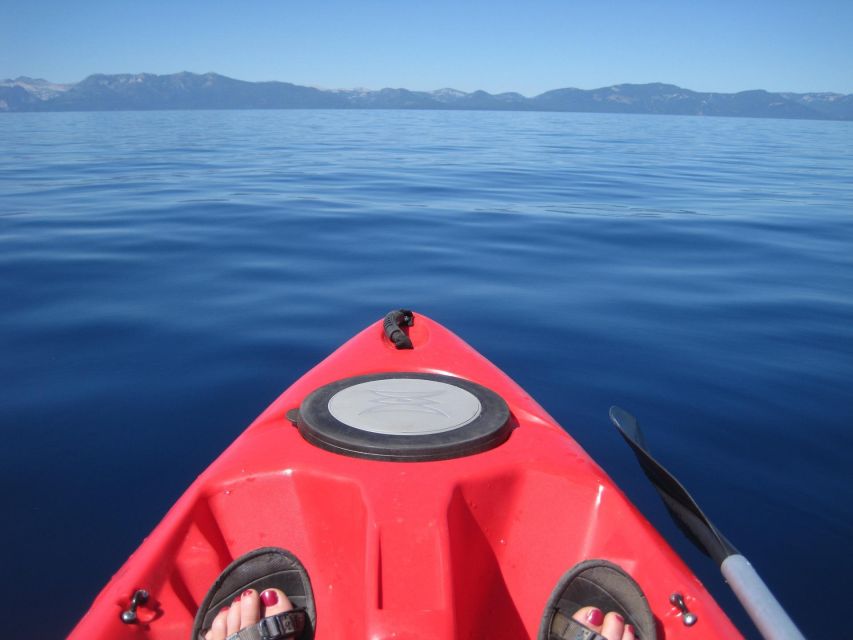 Explore Santorini's Waters: Kayak Rental Adventure - Clear water, black sand, and a close shoreline view