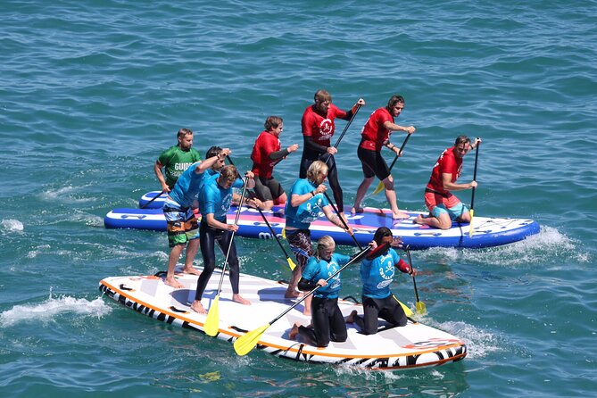 Giant Stand Up Paddle Boarding Experience in Newquay - Learning to work as one crew