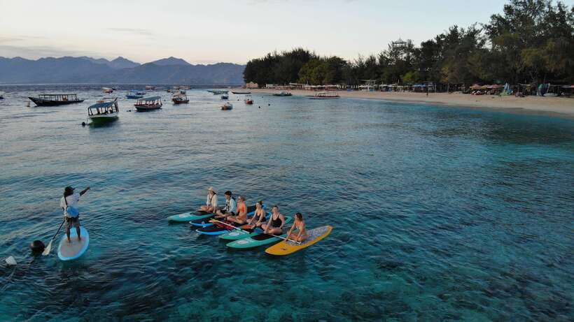 gili sunrise Stand-up paddle boarding or kayaking (droneshot - Looking for turtles in the Gili water