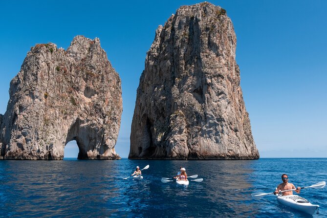 Kayak tour in Capri between caves and beaches. Photos included. - Getting close to the Faraglioni