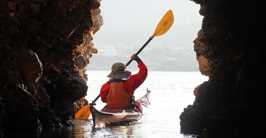 Naxos: Moutsouna Caves Sea Kayak Tour, Snorkeling & Picnic - Paddling through caves and volcanic rock