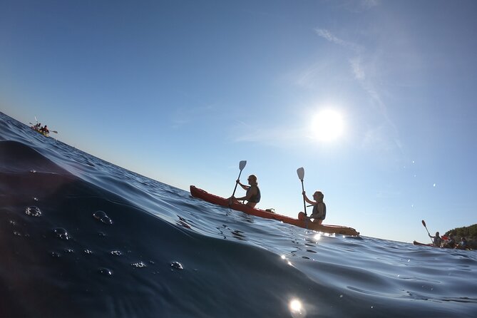 Pula: Sunset Adventure – Boat, Kayak, Snorkeling & Sunset - Paddling beneath Muzil’s high cliffs